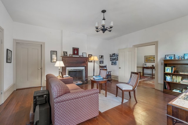 171 Jefferson Ave, Talbotton, GA 31827 - living area featuring a fireplace, wood finished floors, and a notable chandelier