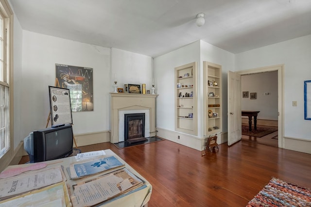 171 Jefferson Ave, Talbotton, GA 31827 - living room with a glass covered fireplace, built in features, and wood finished floors