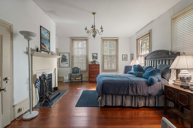 171 Jefferson Ave, Talbotton, GA 31827 - bedroom with a fireplace, a chandelier, and hardwood / wood-style floors