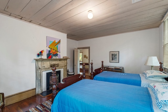 171 Jefferson Ave, Talbotton, GA 31827 - bedroom with a fireplace with raised hearth, baseboards, wood ceiling, and wood finished floors