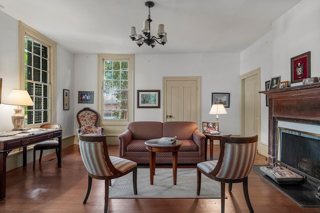 171 Jefferson Ave, Talbotton, GA 31827 - living area featuring wood-type flooring, a fireplace with raised hearth, and a notable chandelier