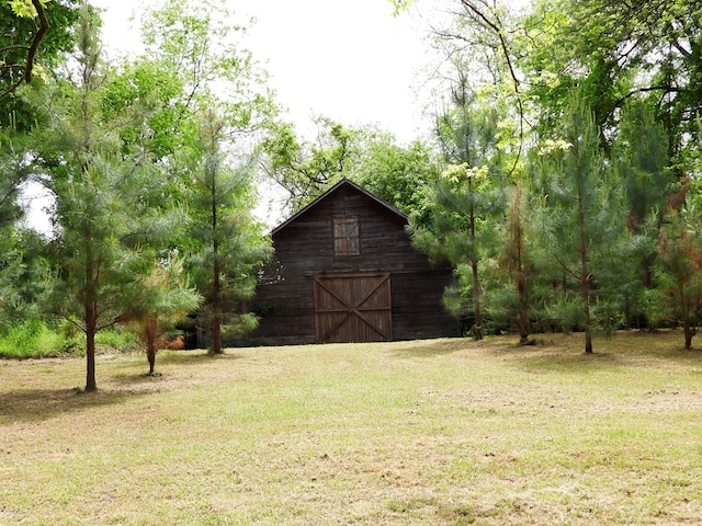 171 Jefferson Ave, Talbotton, GA 31827 - view of yard featuring a detached garage, a barn, and an outbuilding