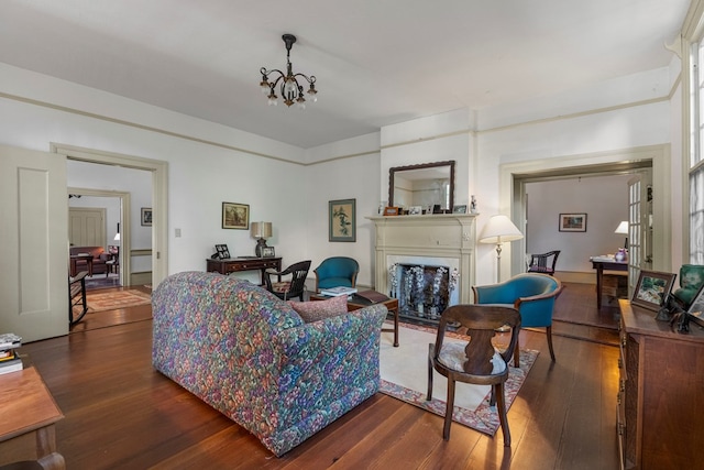 171 Jefferson Ave, Talbotton, GA 31827 - living room featuring a fireplace with flush hearth, an inviting chandelier, and dark wood-style flooring