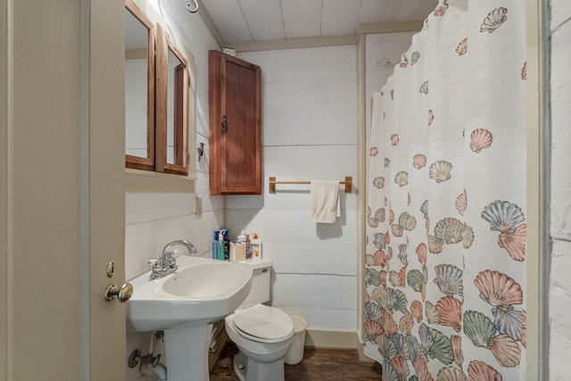 171 Jefferson Ave, Talbotton, GA 31827 - bathroom with wood walls, a shower with shower curtain, wood finished floors, and toilet