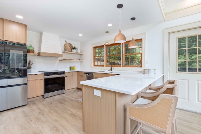 340 Commadore Dr, Hamilton, GA 31811 - kitchen with stainless steel appliances, custom range hood, light brown cabinets, open shelves, and a peninsula