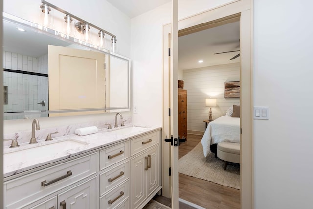 340 Commadore Dr, Hamilton, GA 31811 - full bathroom with wood finished floors, double vanity, a shower with door, ensuite bath, and a ceiling fan