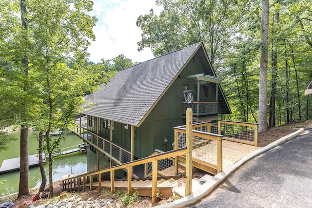 340 Commadore Dr, Hamilton, GA 31811 - view of home's exterior with a shingled roof, board and batten siding, and a deck with water view