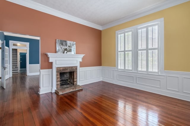 unfurnished living room featuring dark hardwood / wood-style floors, a fireplace, and crown molding