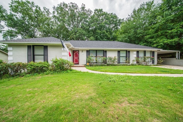3 Primrose Ct, Columbus, GA 31907 - ranch-style home with brick siding, an attached carport, a front lawn, roof with shingles, and concrete driveway