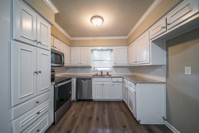 3 Primrose Ct, Columbus, GA 31907 - kitchen featuring appliances with stainless steel finishes, ornamental molding, white cabinets, dark wood-style floors, and light stone countertops