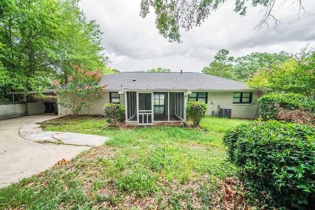 3 Primrose Ct, Columbus, GA 31907 - back of property featuring a sunroom, concrete driveway, a lawn, and stucco siding