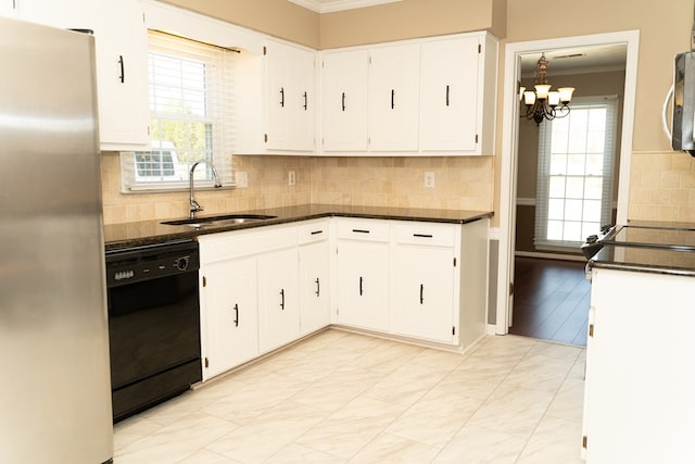 kitchen featuring sink, plenty of natural light, stainless steel fridge, dishwasher, and white cabinets