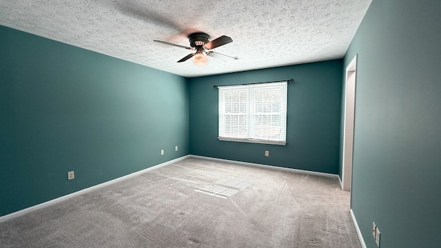 unfurnished room featuring light carpet, a textured ceiling, and ceiling fan