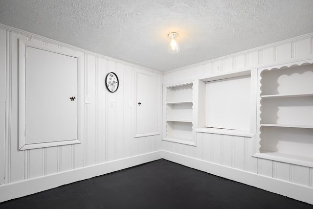 empty room featuring built in features and ornamental molding