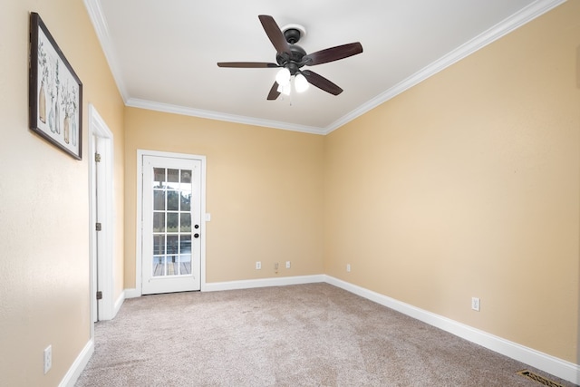 carpeted spare room featuring ceiling fan and ornamental molding