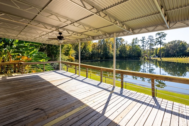 wooden terrace featuring ceiling fan and a water view