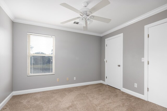 carpeted empty room featuring ceiling fan and ornamental molding