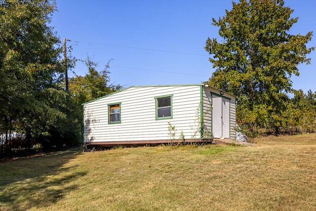 view of outdoor structure featuring a lawn