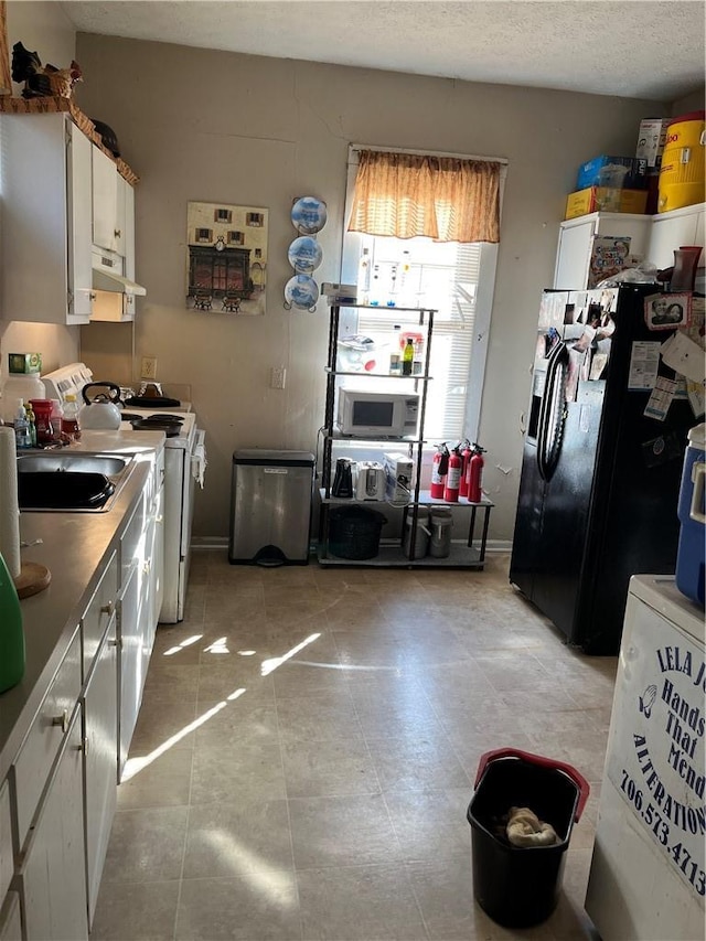 1228 12th Ct, Phenix City, AL 36867 - kitchen featuring white appliances, range hood, white cabinets, and light tile patterned floors