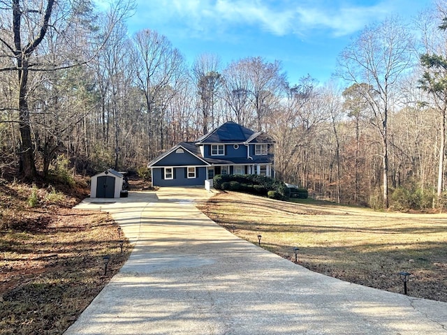 view of front facade featuring a front lawn and a storage unit