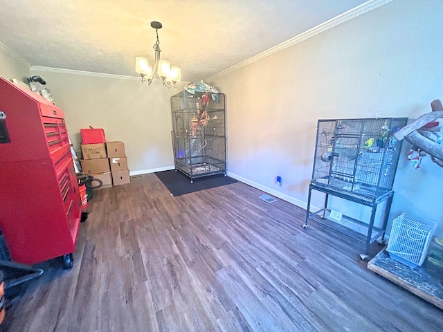 interior space with wood-type flooring, ornamental molding, and a notable chandelier