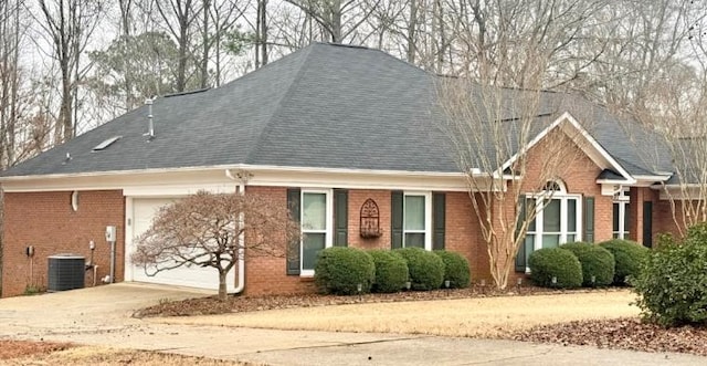 exterior space with central AC unit and a garage