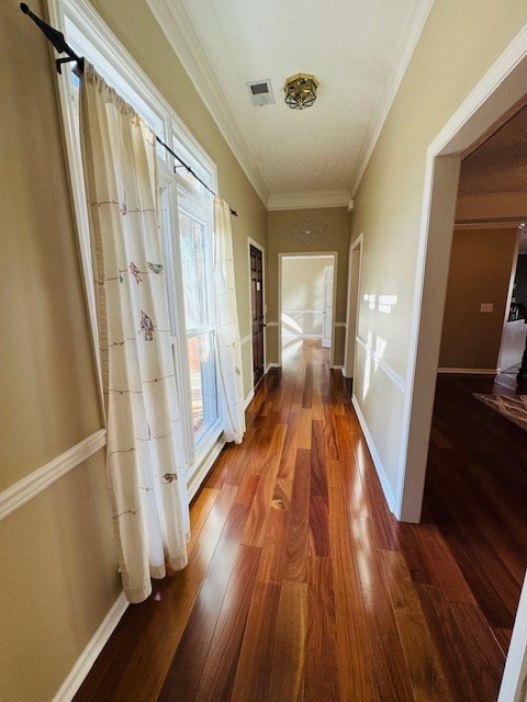 hallway featuring ornamental molding and wood-type flooring