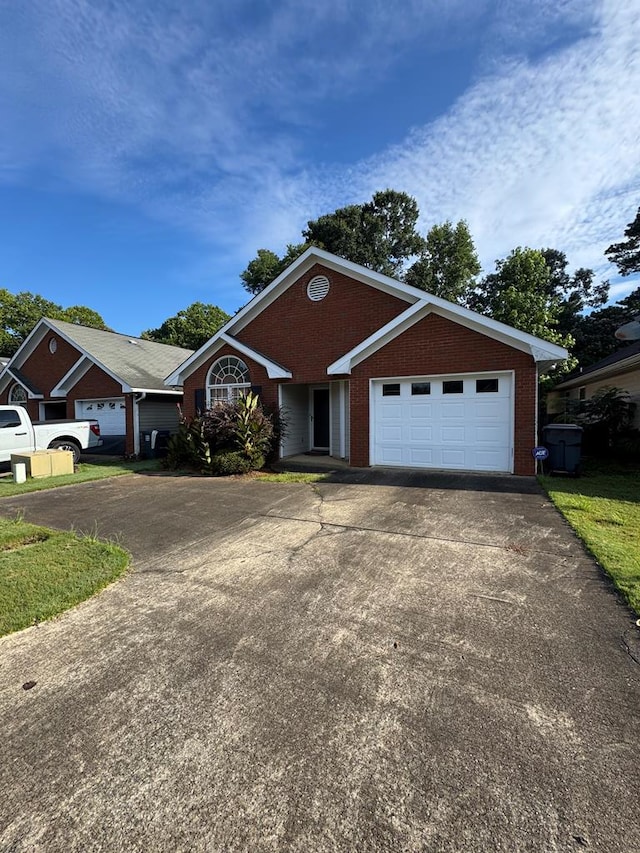 3802 Holland Ct, Phenix City, AL 36867 - ranch-style house with concrete driveway, an attached garage, and brick siding
