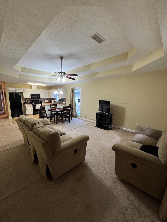 3802 Holland Ct, Phenix City, AL 36867 - living room featuring a tray ceiling, a textured ceiling, light carpet, and ceiling fan