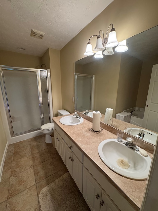 3802 Holland Ct, Phenix City, AL 36867 - bathroom featuring a stall shower, double vanity, a chandelier, and a textured ceiling