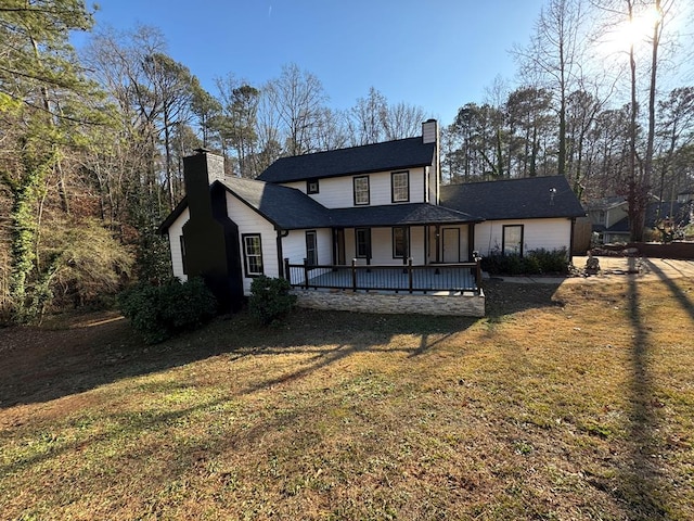 172 SE Oak Forest Dr, Smryna, GA 30082 - back of property with a chimney, a lawn, and covered porch
