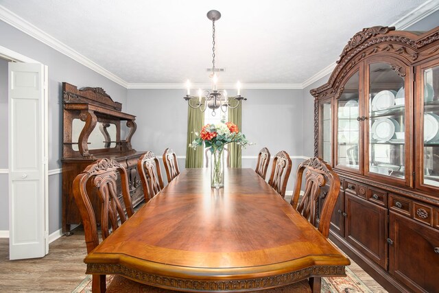 6909 Trapper Way, Midland, GA 31820 - dining room with a chandelier, ornamental molding, and light wood-style flooring