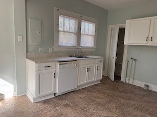 kitchen with white dishwasher, a sink, white cabinets, light countertops, and dark colored carpet