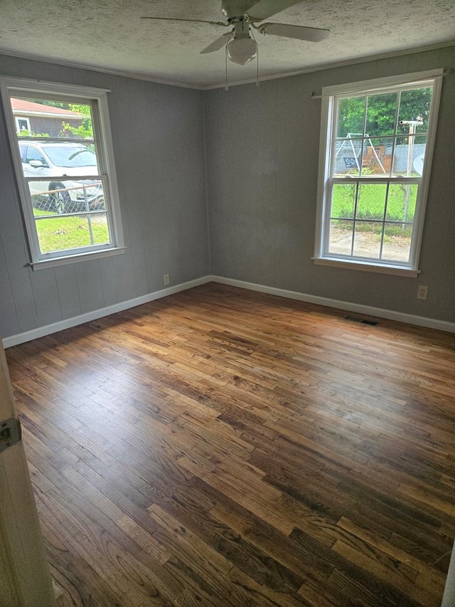 1704 18th St, Phenix City, AL 36867 - empty room with dark wood-style flooring, a ceiling fan, and a textured ceiling