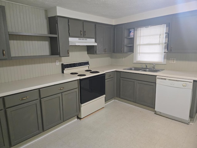1704 18th St, Phenix City, AL 36867 - kitchen with white appliances, open shelves, under cabinet range hood, light flooring, and a textured ceiling