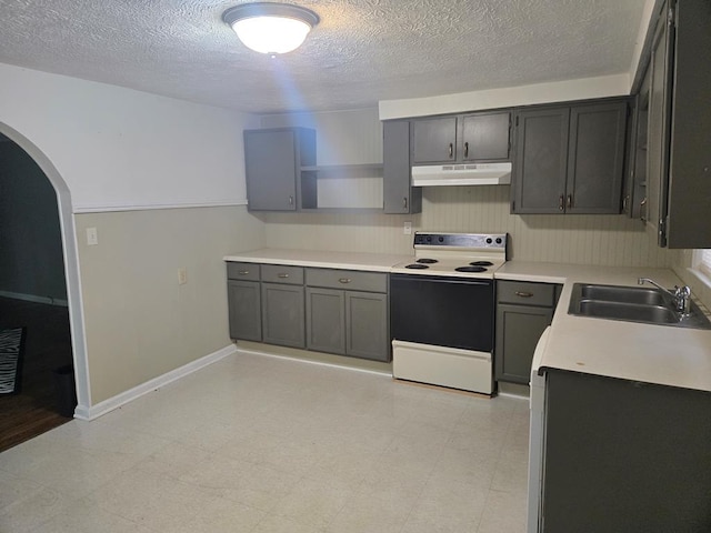 1704 18th St, Phenix City, AL 36867 - kitchen with under cabinet range hood, electric range, open shelves, arched walkways, and a textured ceiling