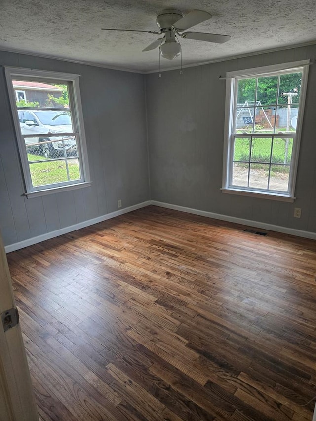 1704 18th St, Phenix City, AL 36867 - spare room with dark wood finished floors, plenty of natural light, ceiling fan, and a textured ceiling