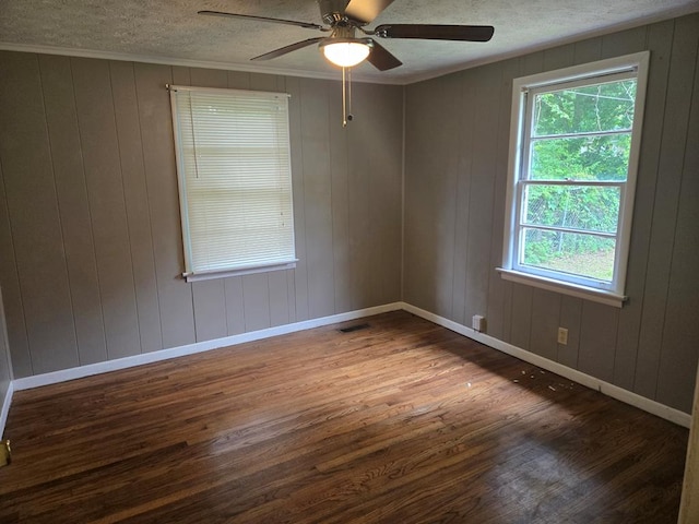1704 18th St, Phenix City, AL 36867 - empty room with wood finished floors, a ceiling fan, a textured ceiling, ornamental molding, and wooden walls