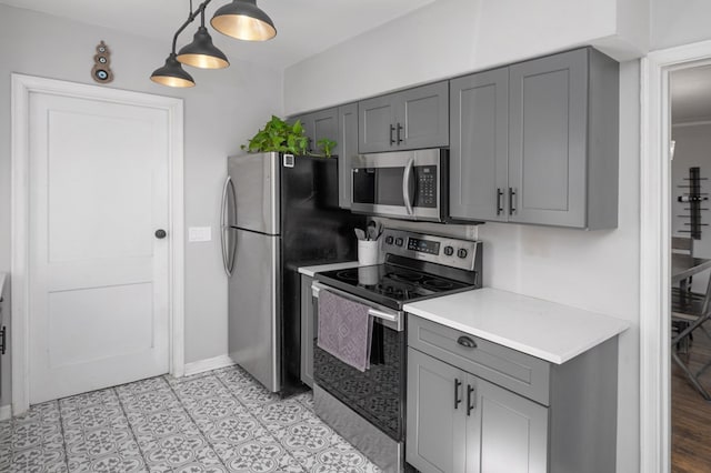 kitchen with gray cabinetry, light countertops, and stainless steel appliances