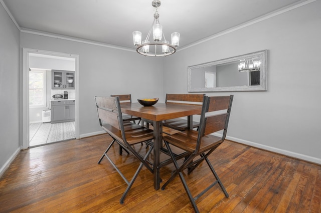 dining area featuring baseboards, an inviting chandelier, and ornamental molding