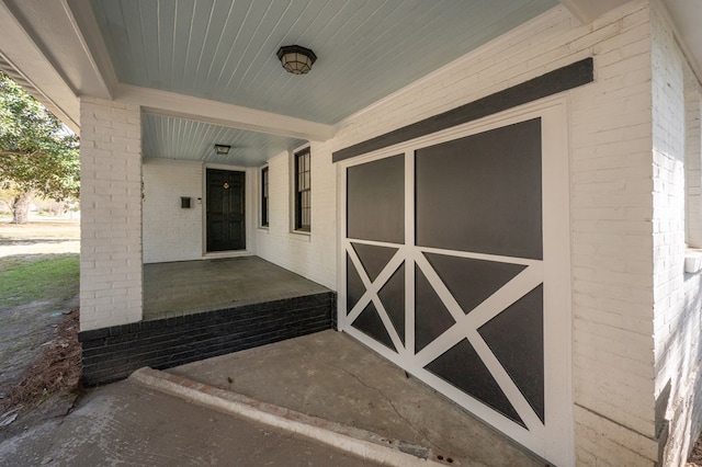 doorway to property with brick siding