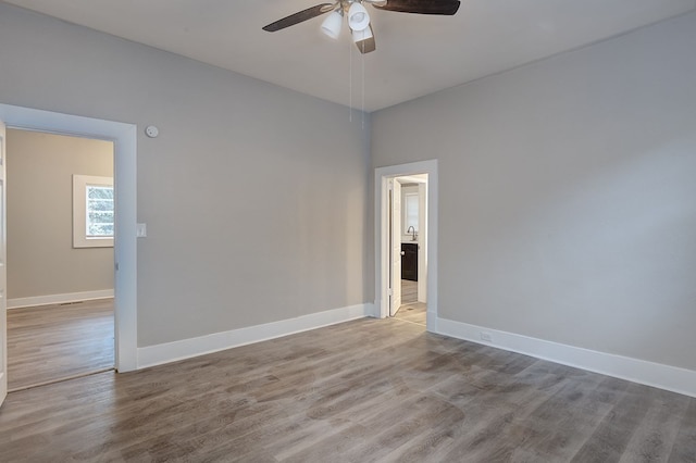 unfurnished room with ceiling fan and light hardwood / wood-style floors