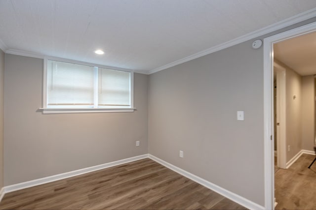 empty room featuring hardwood / wood-style floors and ornamental molding