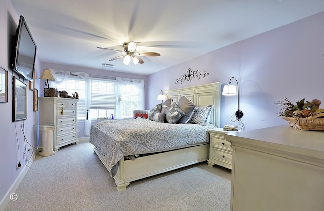 bedroom with light colored carpet and ceiling fan