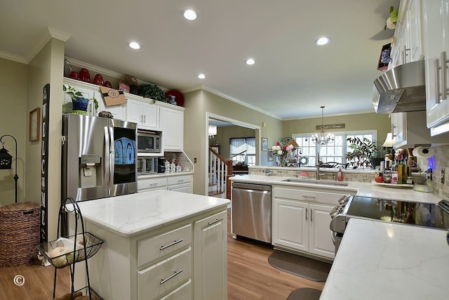 kitchen with backsplash, hanging light fixtures, light stone countertops, white cabinetry, and stainless steel appliances