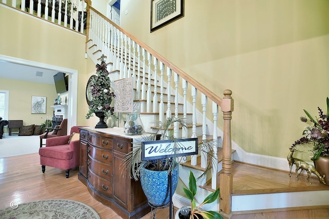 staircase featuring wood-type flooring