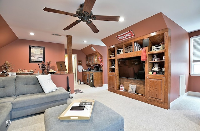 living room featuring vaulted ceiling, ceiling fan, built in features, bar, and light colored carpet