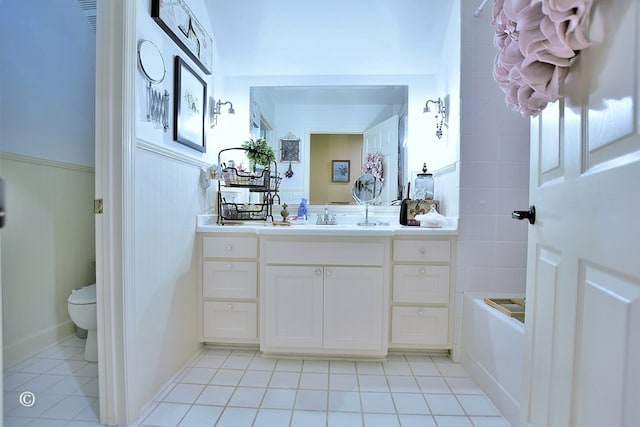 bathroom featuring tile patterned floors, vanity, and toilet