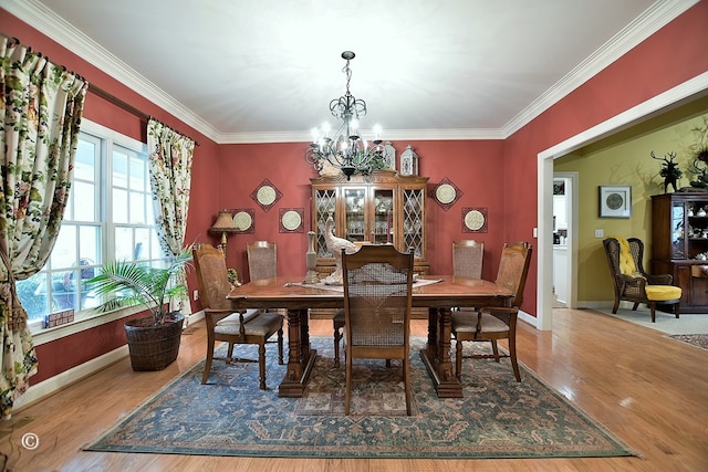 dining room with crown molding, wood-type flooring, and a notable chandelier