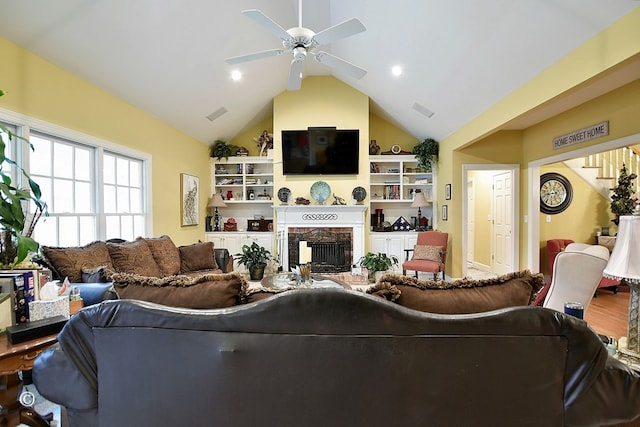 living room featuring ceiling fan, hardwood / wood-style floors, a high end fireplace, and lofted ceiling